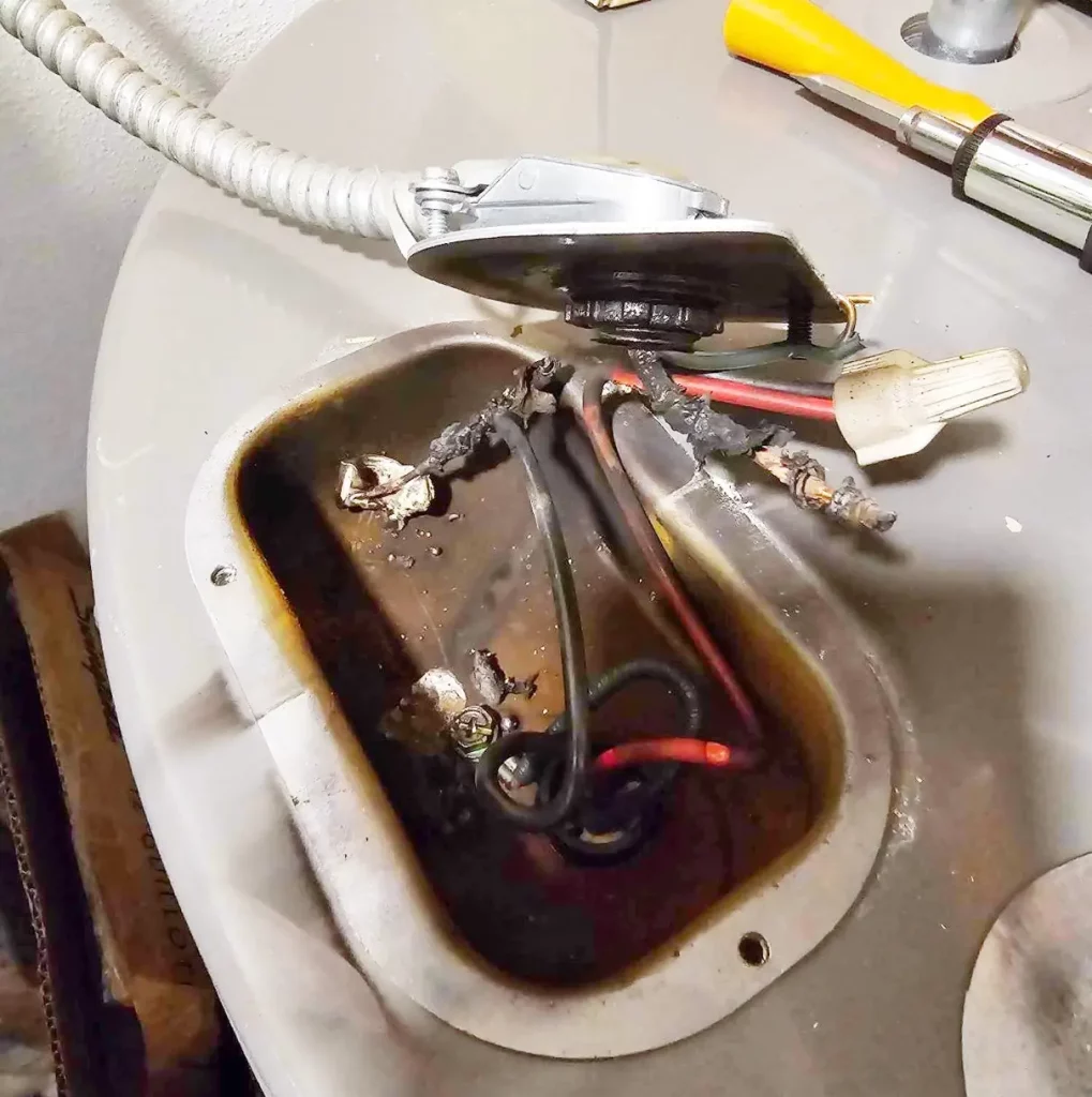 Melted, scorched electrical outlet showing heat damage